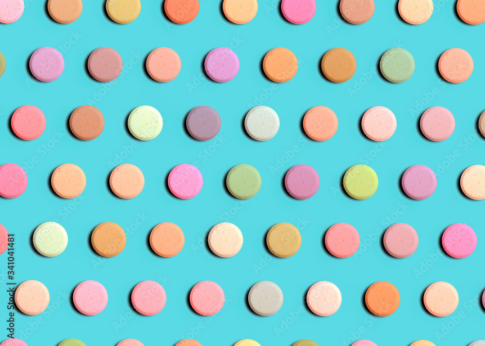 Seamless pattern of pharmaceutical pills or vitamins on a blue background. Multi-colored pills on a blue background. Seamless pattern of pharmaceutical pills or vitamins on a blue background. Multi-colored pills on a blue background.