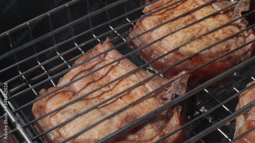 Pork steaks cooked on a charcoal grill outdoors
