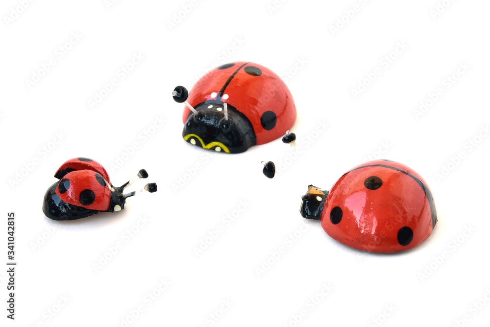 Wooden ladybugs on a white background. Three toy insects Wooden ladybugs on a white background. Three toy insects