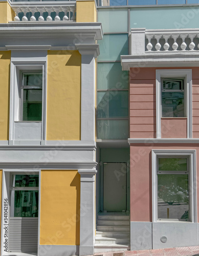 modern interpratation of classic building design with pink and yellow wall and white frame openings