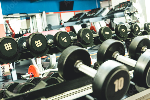 Dumbbells in the interior of the gym without people