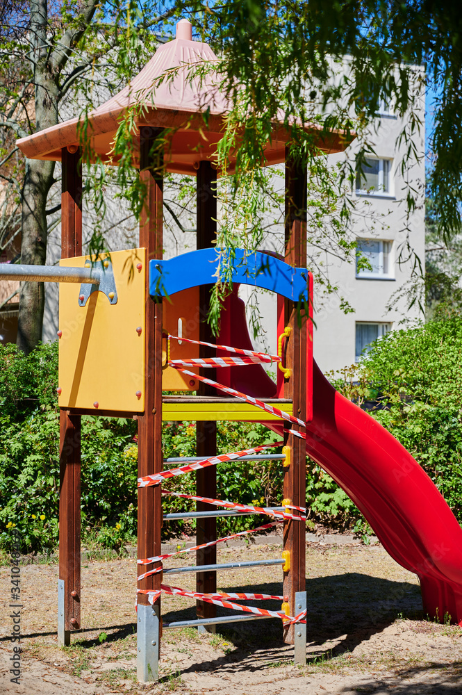 Children's playground in Berlin, Germany, which was closed due to the Covid-19 virus and the blocking of contact with a barrier tape. Children's playground in Berlin, Germany, which was closed due to the Covid-19 virus and the blocking of contact with a barrier tape.