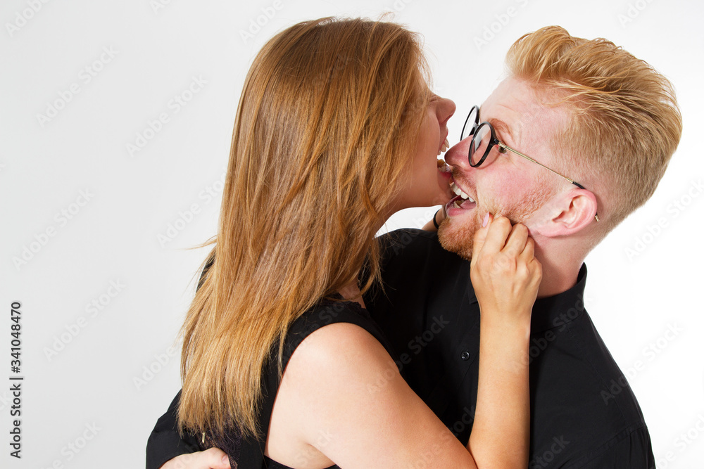 Fashionable red hair couple, Young beautiful couple in Black clothes, Portrait of a woman and man, Close up of a couple hugging at home isolated on white background Fashionable red hair couple, Young beautiful couple in Black clothes, Portrait of a woman and man, Close up of a couple hugging at home isolated on white background