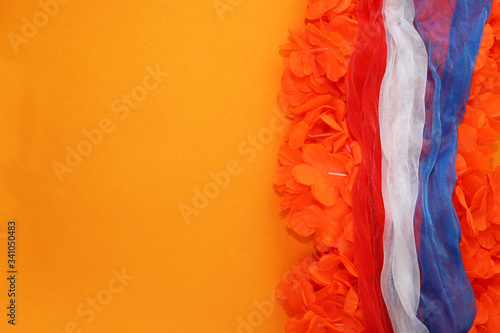 Orange background with typical King's Day accessories.  photo