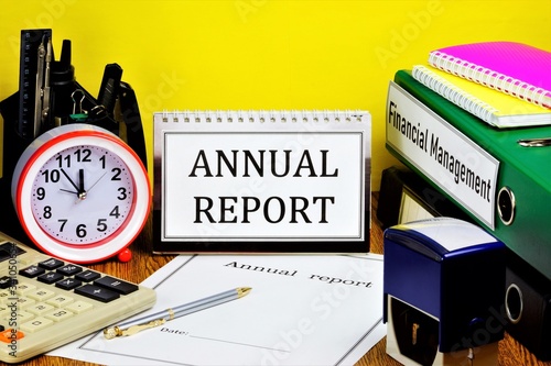 Annual report-text label on the calendar. There are folders with accounting documents on the Manager's Desk. Expresses a reliable opinion of the correctness of the company's activities.