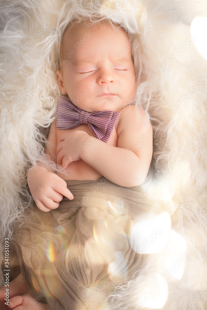 A portrait newborn lies on a fur blanket, cute, sleeping, tiny baby. Mom and her baby. Maternity. Beautiful conceptual image of motherhood. Mothers Day. A portrait newborn lies on a fur blanket, cute, sleeping, tiny baby. Mom and her baby. Maternity. Beautiful conceptual image of motherhood. Mothers Day.