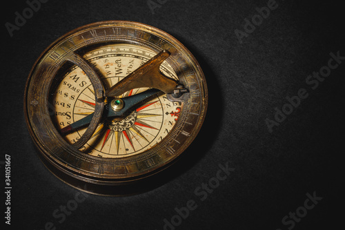 Retro compass on black board background. photo