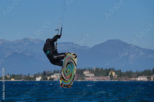 kitesurfer in the jump on a background of high mountains