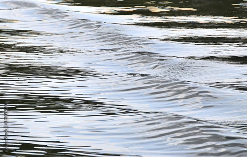 Waterscape with the contrast waves: blue glimpses on the lake. The sequence of embossed waves under dim sky lighting; a series of images, No.4