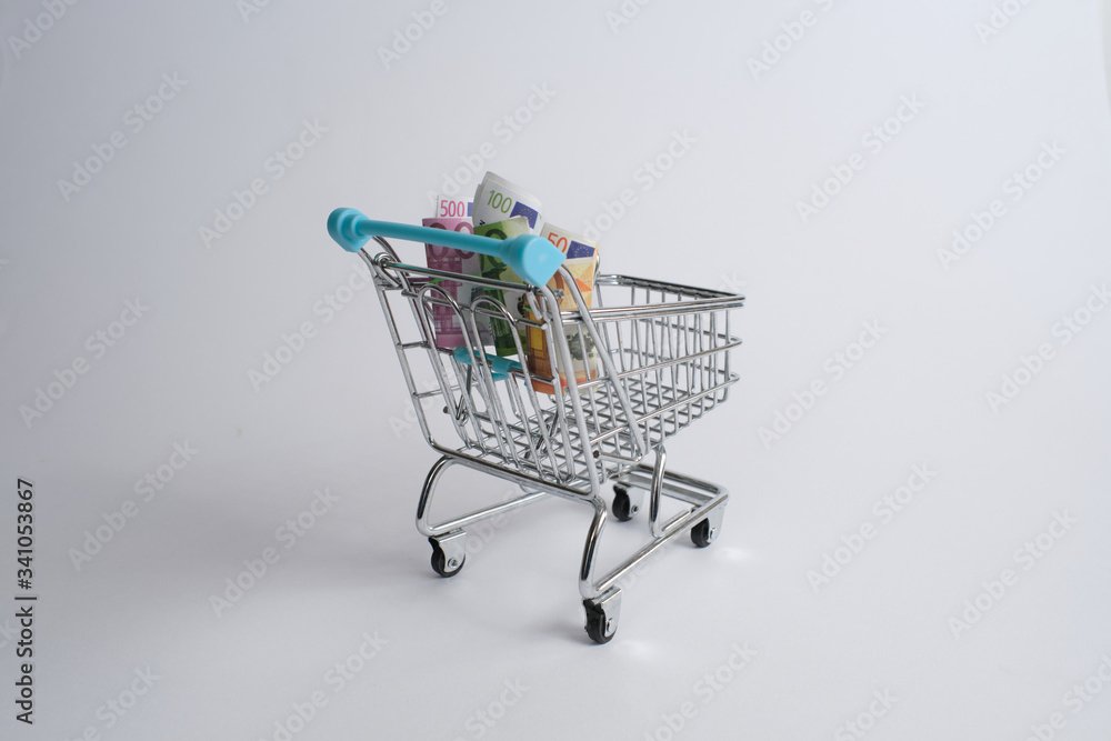 Shopping cart with euro bills. On white background with copy space