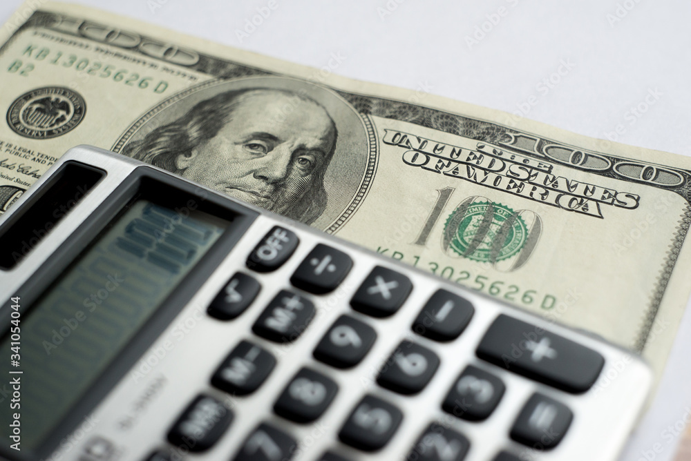 calculator on a white background, one hundred dollars usa calculator on a white background, one hundred dollars usa
