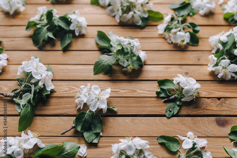 Spring flowering branch on a brown wooden background. Apple blossoms. Close up. Spring flowering branch on a brown wooden background. Apple blossoms. Close up.