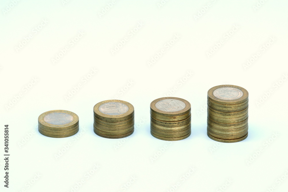 Piles of golden metallic coins. Columns of coins of different heights. The concept of business, economy, finance, investment and prices. Place for text and background for design. Piles of golden metallic coins. Columns of coins of different heights. The concept of business, economy, finance, investment and prices. Place for text and background for design.