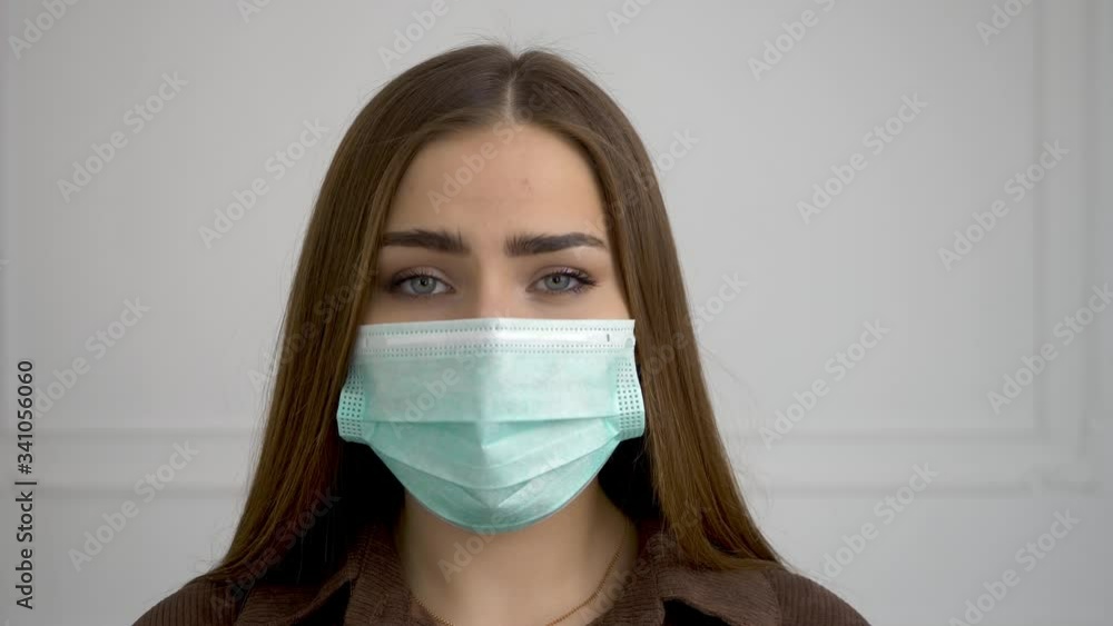 A beautiful girl takes off her medical mask and is happy. She has a smile and a laugh on her face. A beautiful girl takes off her medical mask and is happy. She has a smile and a laugh on her face.