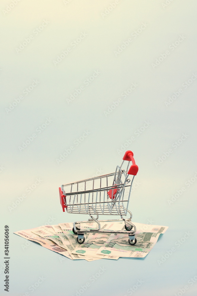 Shopping cart with Russian money. Paper bills and a souvenir shopping basket. Shopping cart with Russian money. Paper bills and a souvenir shopping basket.