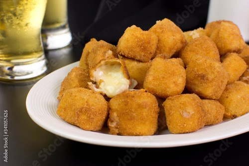 Obraz na płótnie Traditional Brazilian pub food provolone cheese in breadcrumbs called provolone