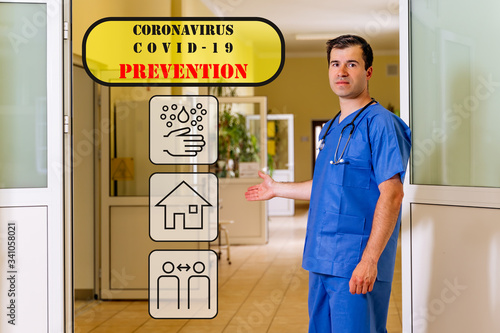Middle age, Caucasian white, male doctor standing in a hospital corridor showing translucent coronavirus or covid 19 prevention icons or graphics
