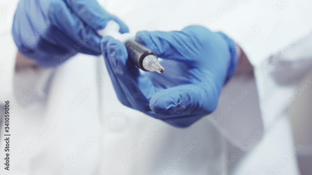 Scientist hand holding Syringe with CBD Cannabidiol paste in a laboratory. Scientist hand holding Syringe with CBD Cannabidiol paste in a laboratory.