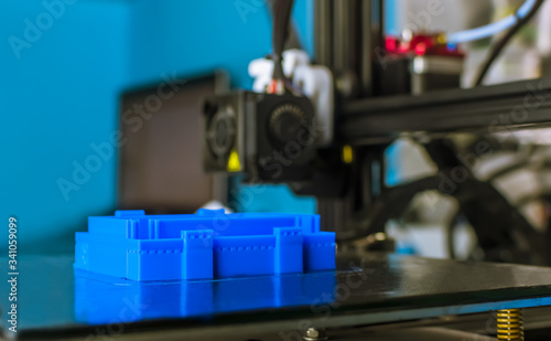 The 3D printer printed blue plastic model