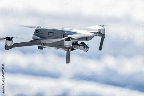 Drone in flight below eye level against a blurred background