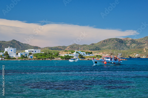 The beach and fishing village of Pollonia with fishing boats in sea. Pollonia town, Milos island, Greece photo