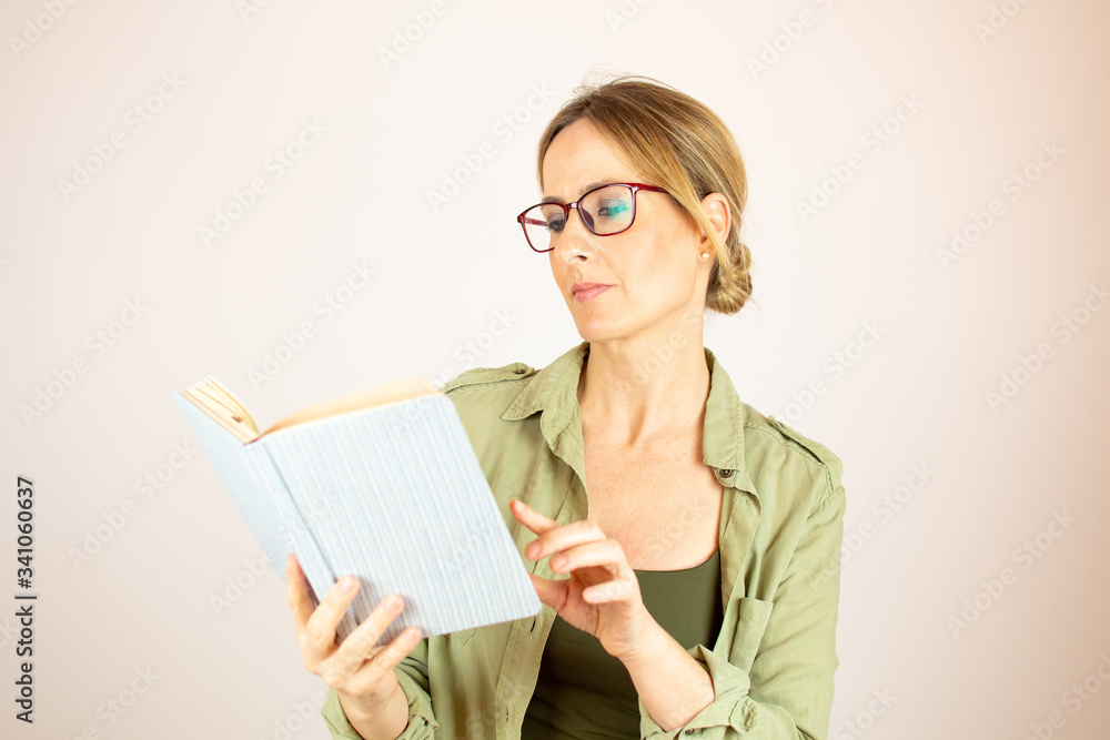 Beautiful woman with glasses reading a book Beautiful woman with glasses reading a book