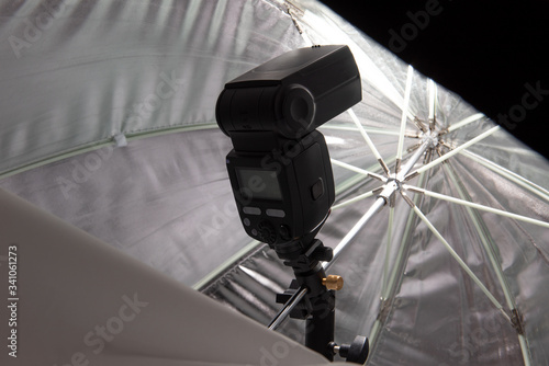 Speedlite firing inside octagonal umbrella softbox photo