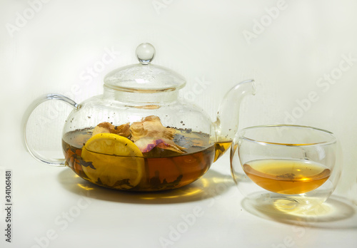 hot tea with rose petals and lemon in a teapot