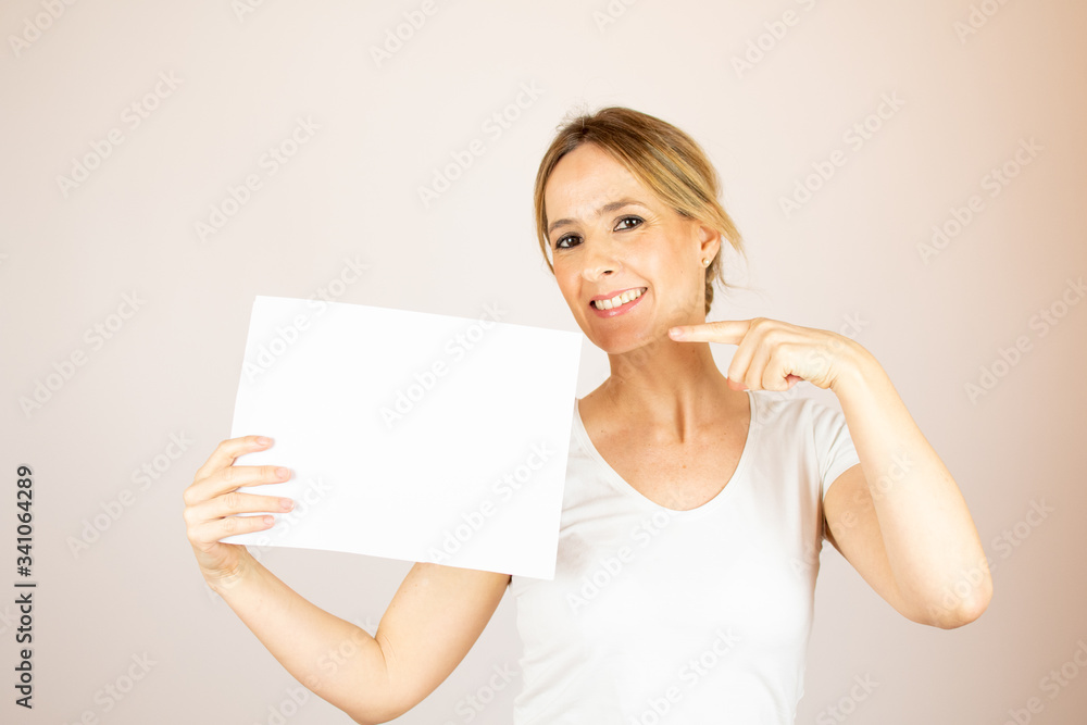 Beautiful woman with paper looking into the camera Beautiful woman with paper looking into the camera