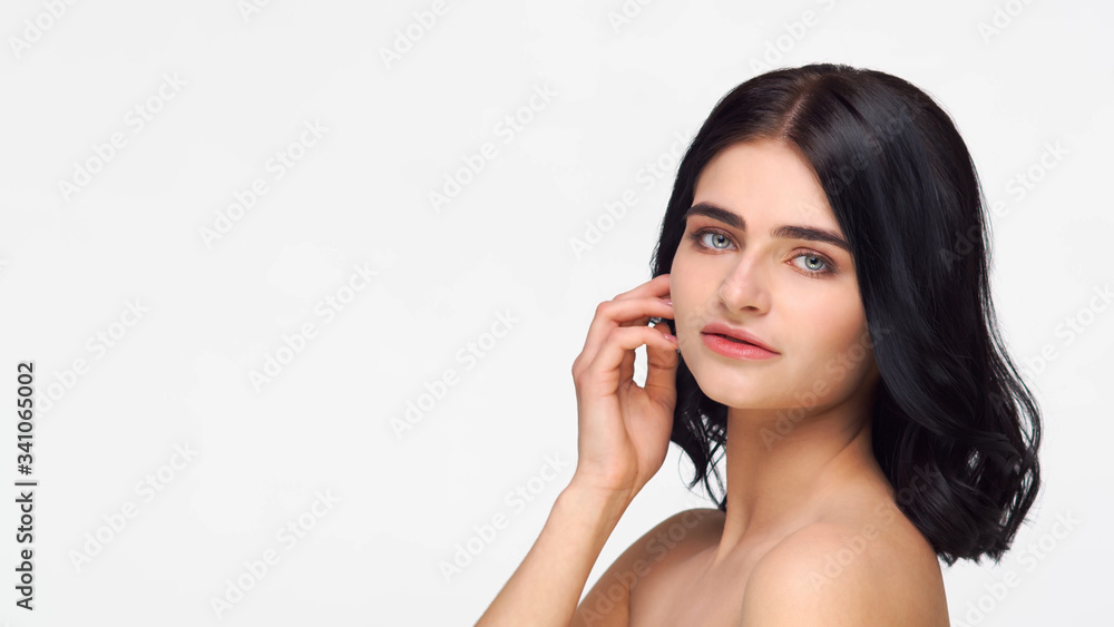 Studio portrait of young and beautiful brunette woman over isolated white background. Skin care, health, makeup and cosmetics. Studio portrait of young and beautiful brunette woman over isolated white background. Skin care, health, makeup and cosmetics.