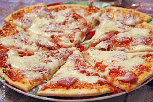 Slices of fresh appetizing pizza with delicious ingredients close up