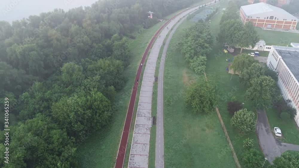 Novosadski kej. Early morning. Fog. Man jogging. Birds-eye view. Aerial footage Novosadski kej. Early morning. Fog. Man jogging. Birds-eye view. Aerial footage