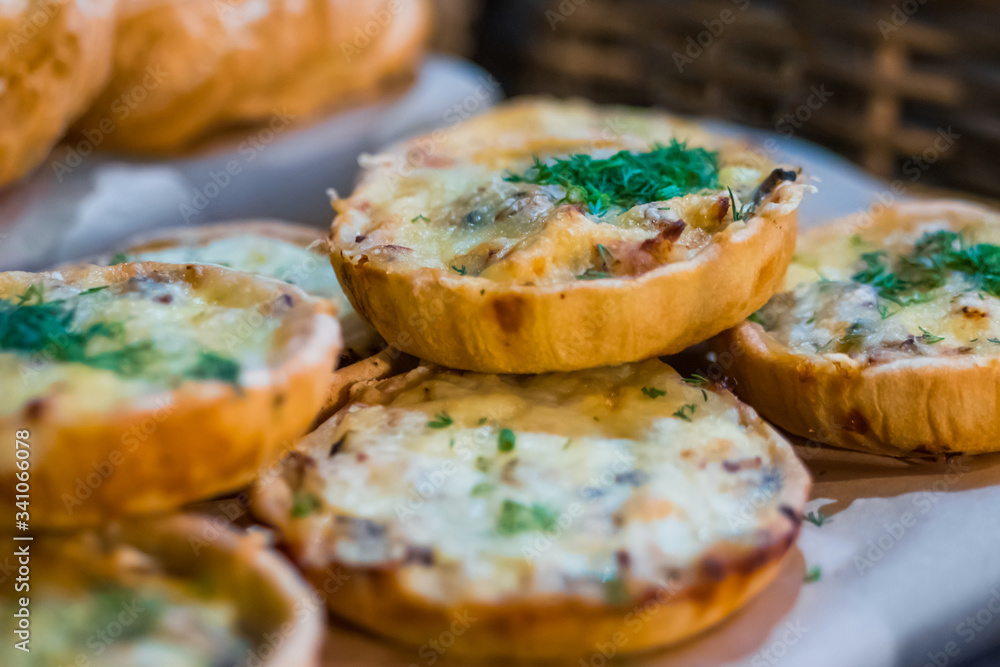 Assortment of delicious freshly baked tart pies with cheese, meat, mushroom and dill for sale on counter of shop, grocery, market, cafe or bakery. Food, gastronomy and pastry concept Assortment of delicious freshly baked tart pies with cheese, meat, mushroom and dill for sale on counter of shop, grocery, market, cafe or bakery. Food, gastronomy and pastry concept