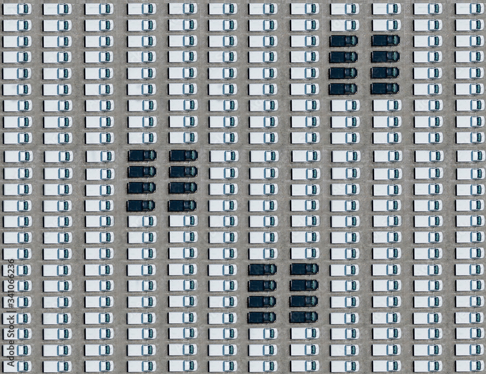 Aerial view of few black cars parked between exclusively white ones Aerial view of few black cars parked between exclusively white ones