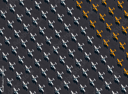 Aerial view of large number of white and orange colored airplanes in airport