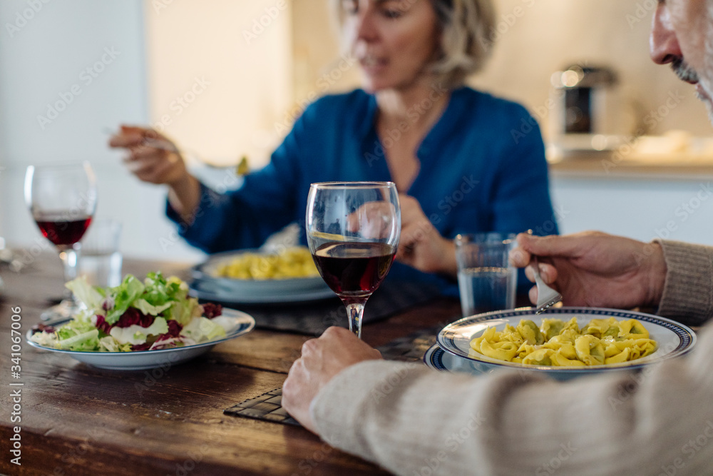 Mature couple having dinner in kitchen at home Mature couple having dinner in kitchen at home