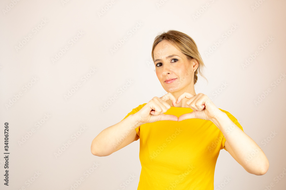 Healthy beautiful woman making a heart gesture Healthy beautiful woman making a heart gesture