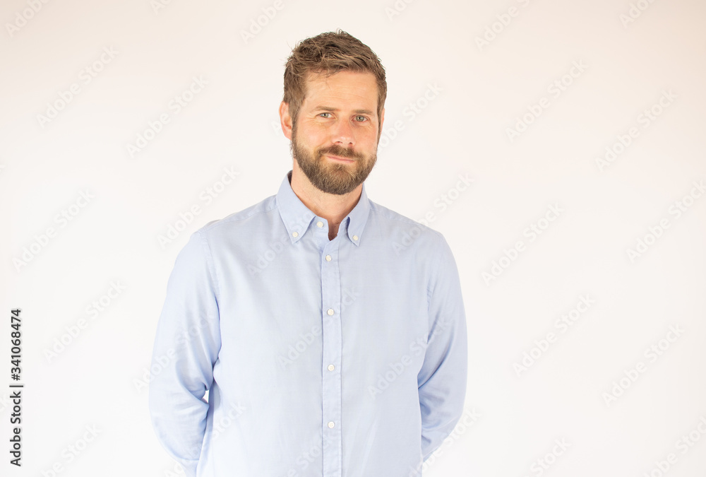 Fototapeta premium handsome young man in blue shirt looking into the camera