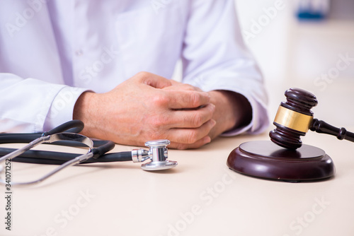 Male doctor in courthouse meeting with lawyer