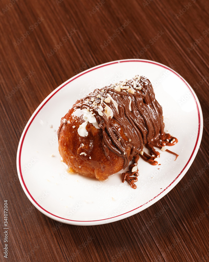 Traditional Italian desert with rum and Nutella cream. Wooden table. Traditional Italian desert with rum and Nutella cream. Wooden table.