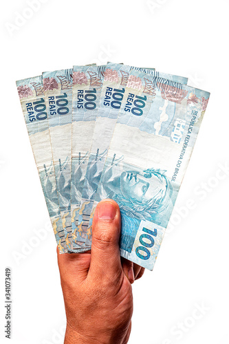 100 reais bills from Brazil, held by male hand on isolated white background. Banknotes of one hundred reais from brazil, payday.