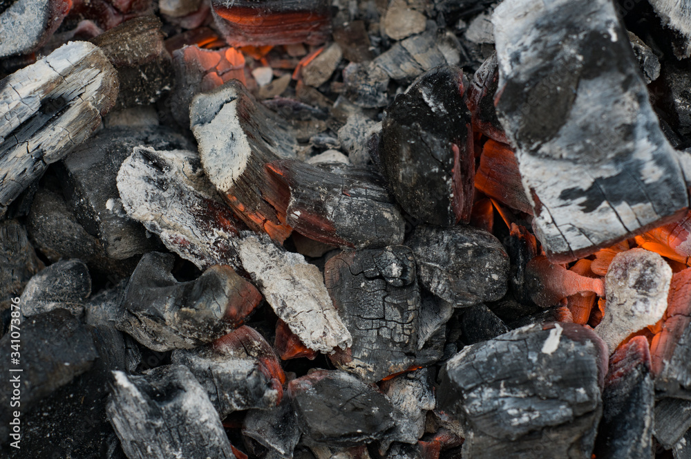 Smoldering black embers. Natural background. Grilling concept. Burnt wood. Fireplace. Fire. Ashes in fire pit Smoldering black embers. Natural background. Grilling concept. Burnt wood. Fireplace. Fire. Ashes in fire pit