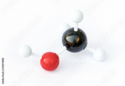 Plastic ball-and-stick model of a methanol molecule (chemical formula CH3OH) on a white background.  photo