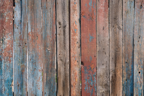 Wooden grey background. Brown, grey, red, blue wood texture. Vertically arranged close-up wood planks. Gray and light blue wood vertical boards. .