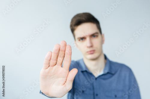 Man making stop signal. Man with with outstretched arm. Young man saying no