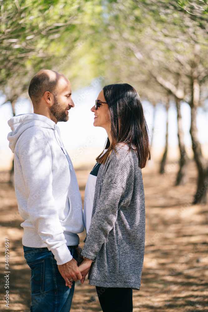 Couple holding hands in a park, face to face Couple holding hands in a park, face to face