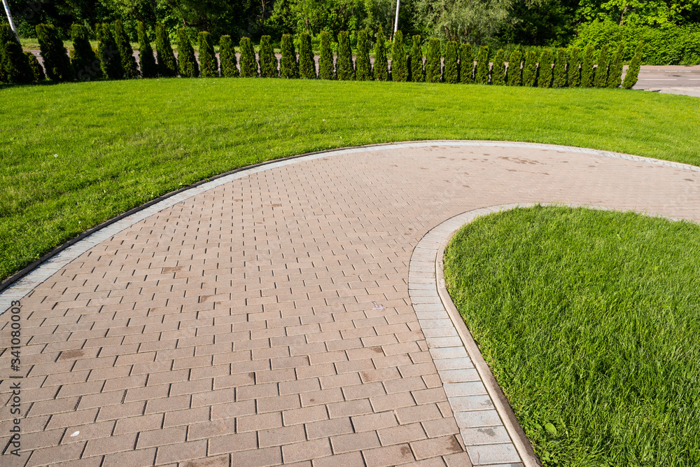 curved stone walkway from pavers in landscape design and sidewalk decoration Stock Photo Adobe