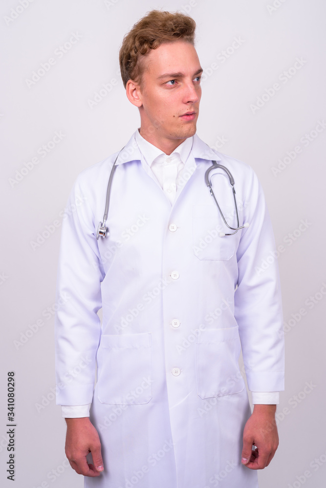 Young handsome Scandinavian man doctor against white background Young handsome Scandinavian man doctor against white background