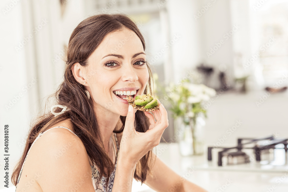 Portrait of a woman eating a healthy avocado bread Portrait of a woman eating a healthy avocado bread