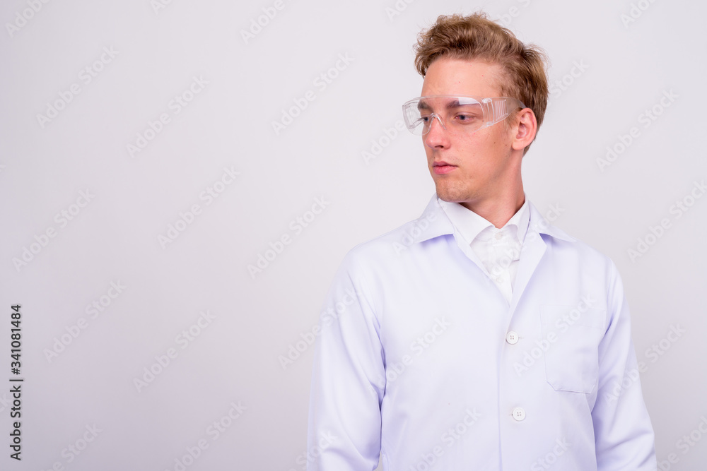 Young handsome Scandinavian man doctor against white background Young handsome Scandinavian man doctor against white background